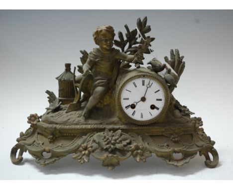 A late 19th century spelter cased mantel clock, the circular enamelled dial with Roman numerals and eight day movement, the w