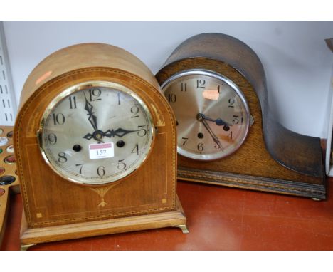 An Edwardian mahogany cased and chequer strung dome-top mantel clock. having a silvered dial with Arabic numerals and eight d
