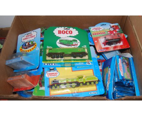 A box containing a large quantity of Ertl Thomas the Tank Engine carded diecast trains, collectors cards and other associated