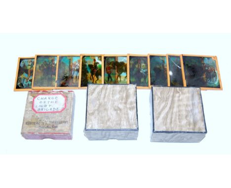 A collection of boxed early 20th century magic lantern slides subjects to include the Charge of the Light Brigade, Paris 1889