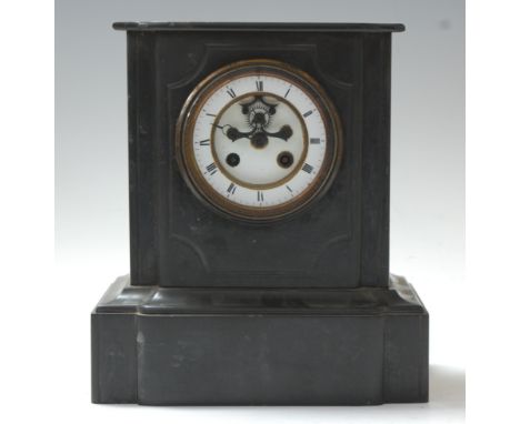 A late Victorian black slate mantel clock, of typical form, having enamelled chapter ring with Roman numerals, visible escape