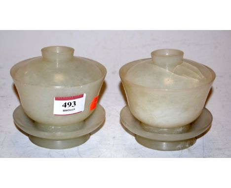 A pair of Chinese jade(?) jars and covers on stands, h.9cm