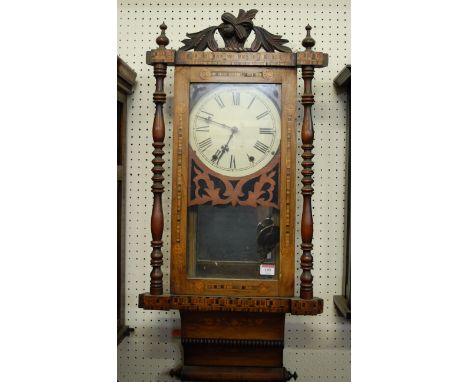 A 19th century walnut and specimen wood inlaid cased wall clock having carved pediment, enamel dial with Roman numerals flank