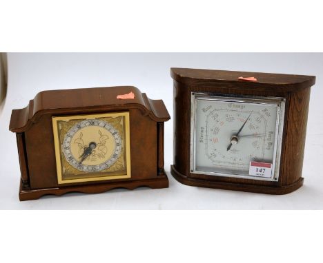 A mid 20th century walnut cased mantel clock by Elliot of London having a silvered chapter ring with Roman numerals, together