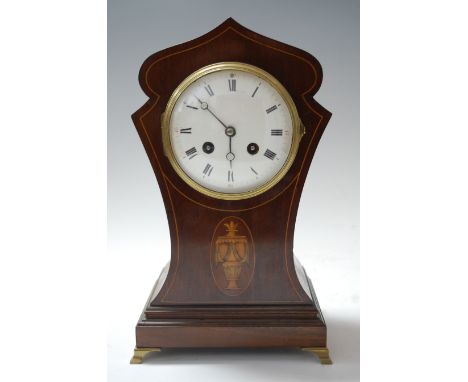 An Edwardian mahogany and satinwood inlaid cased mantel clock, of unusual shaped outline, having convex enamelled dial, with 