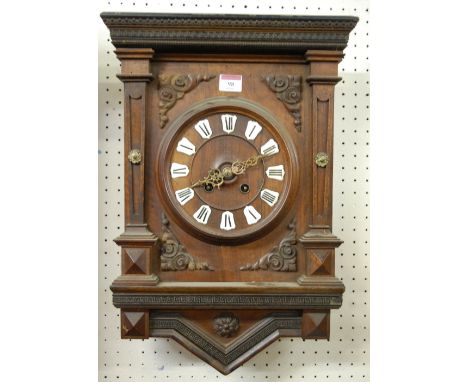 A late 19th century Continental oak cased wall clock having a convex enamel markers with Roman numerals and eight day movemen
