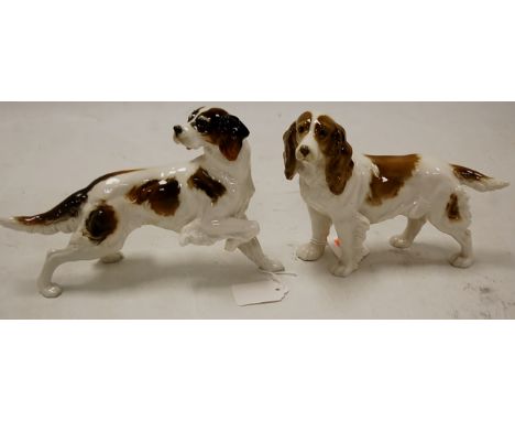 A 20th century German porcelain model of a spaniel, height 15cm, together with one other similar (2)