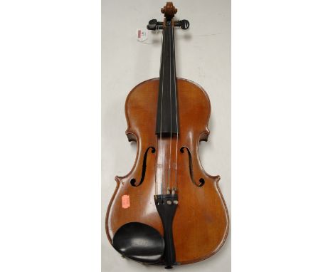 An early 20th century Continental violin, having ebony fingerboard and two-piece back, case back length 39cm (excluding butto