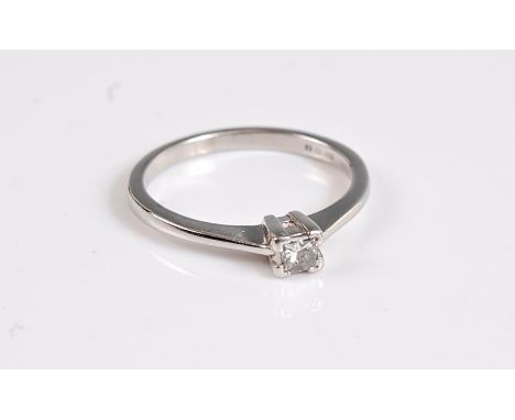 A platinum diamond solitaire ring, the princess cut diamond, estimated approx. 0.15cts, in a four claw mount and plain band s