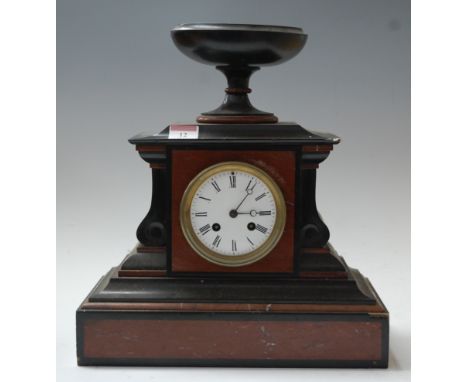 A late 19th century black slate and rouge marble cased mantel clock, of architectural form, the whole surmounted by an urn, h