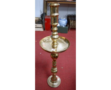 A large Eastern brass candlestick, h.91cm
