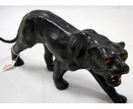 An early 20th century leather clad model of a puma, length 41cm