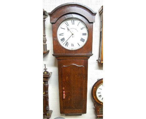 A Great Western Railway oak cased drop trunk wall clock having a 14" circular dial with Roman numerals signed Great Western R
