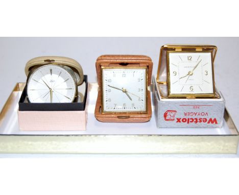 A Westclox Voyager travel alarm clock; together with two others (3)