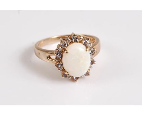 A 10k opal cluster ring, the oval opal cabochon, surrounded by alternating pale lavender and white hardstones, all claw mount