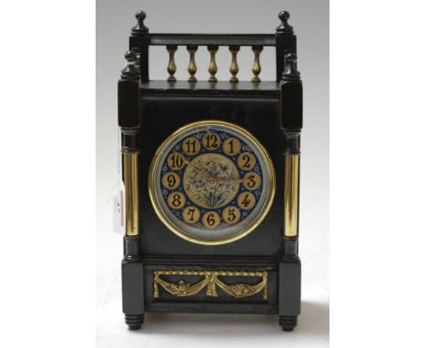A late Victorian Aesthetic Movement ebonised cased mantel clock, having pierced gallery above circular dial, with gilt Arabic
