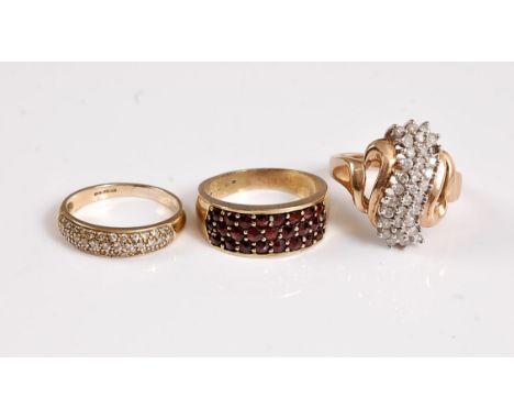 A 9ct one third set diamond pave ring, size K, a 9ct three row garnet ring, size M, and a 10k diamond dress ring, size M, (11