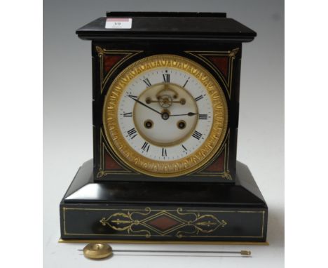 A late Victorian black slate, rouge marble and cut brass inlaid mantel clock, having enamelled chapter with Roman numerals, v