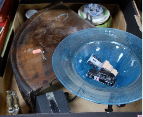 A box of miscellaneous items to include blue glass table bowl with bubble inclusions, a large brass table lighter, mahogany c