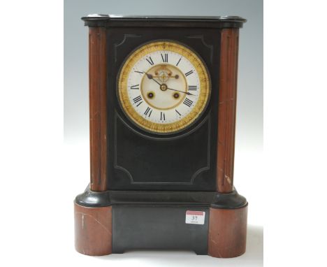 A late Victorian black slate and rouge marble mantel clock, having enamelled chapter ring with Roman numerals, visible anchor