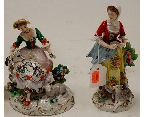 An ealry 20th century Sitzendorf porcelain figure in the form of a seated lady with a dog on her lap and a lamb at her feet, 