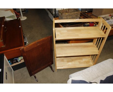 A modern light wood folding bookcase and a wooden fire screen