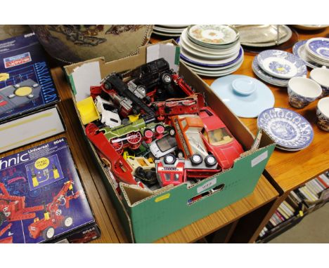 A box of various plastic and die cast model vehicles