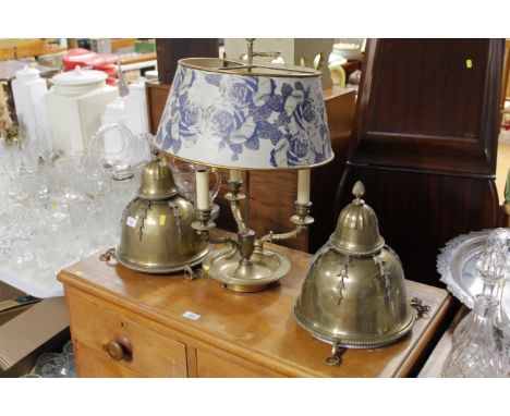 Two Eastern brass hanging lamps and a brass three light table light and shade 