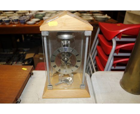 A skeleton type mantel clock in case