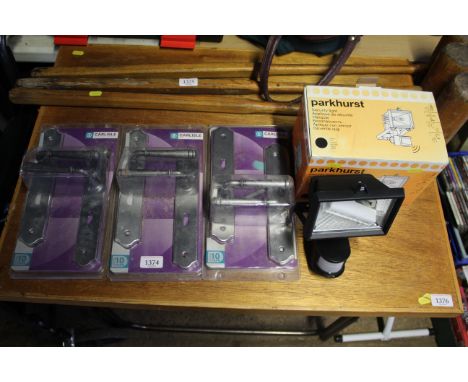 A Parkhurst outdoor security light and three packs of Carlisle door handles 