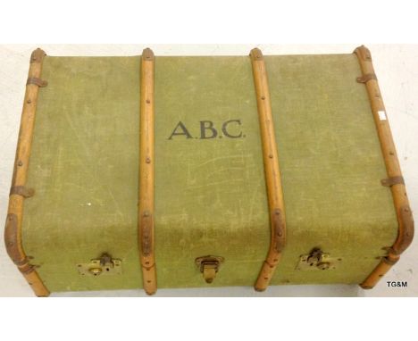 A travelling trunk cloth covered wooden banded with leather handles 32 x 76 x 50