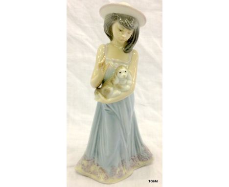 A Lladro figure of a girl holding a dog 21cm high