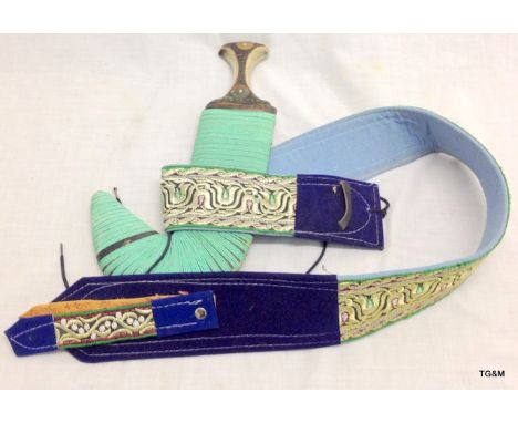 An Arab curved dagger with horn handle and decorative belt