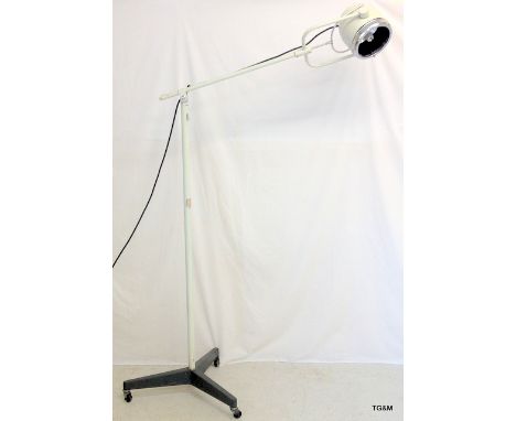 A vintage industrial white enamelled adjustable mobile spot lamp 