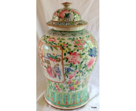 Large Chinese famille rose baulster jar and cover  with panels of courtly figures. 44cm High