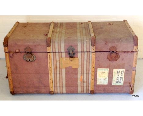 A large wooden bound upholstered vintage trunk