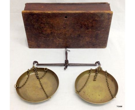 A pair of antique brass scales in an oak box
