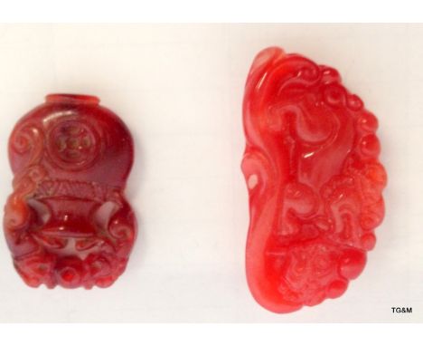 A red jade dragon pendant and a red Jade pendant in the form of an urn