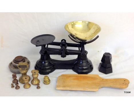 A pair of black painted cast iron kitchen scales with weights