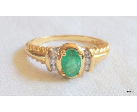 A ladies 9ct gold emerald and diamond ring. size N