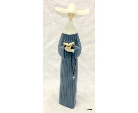 A Lladro figure of a nun 26cm high