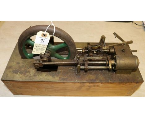 A live steam stationary engine. A scratch built single cylinder engine of some age. Generally well built and mounted on a bra