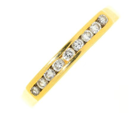 A nine stone diamond ring, channel set in 18ct gold, marks obscured, 2.8g, size N½ Light wear