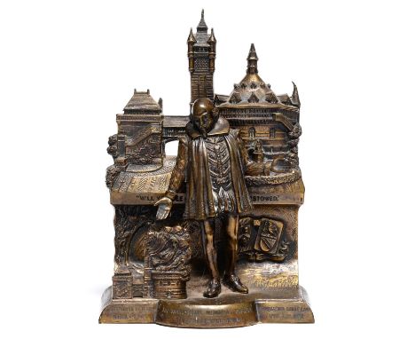 A brass statuette of William Shakespeare standing before the burning ruins of the memorial theatre Stratford-upon-Avon, 1926,