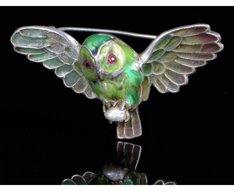 A French silver and enamel owlet brooch, early 20th c, with plique a jour wings, red stone eyes and a baroque pearl in its ta