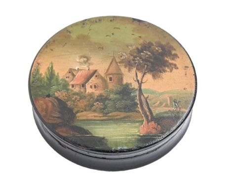 A papier mache snuff box and cover, c1840, the cover painted with a man by a river, 84mm diam Slightly knocked and worn