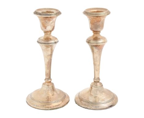 A pair of George V silver candlesticks, with reeded bands, 17.5cm h, marks rubbed, Birmingham 1919, loaded Light wear, not sp