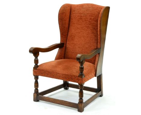 An oak wing armchair, second quarter 20th c, close nailed upholstery, seat height 43cm 