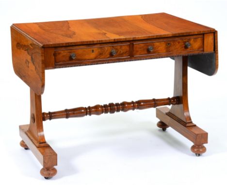 A George IV rosewood sofa table, fitted with drawers and opposing blind drawers, on swept ends with lotus turned stretcher, b