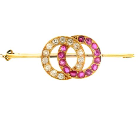 A ruby and diamond linked circles brooch, on associated gold knife wire, 45mm l, marked 9ct, 5.6g Good condition
